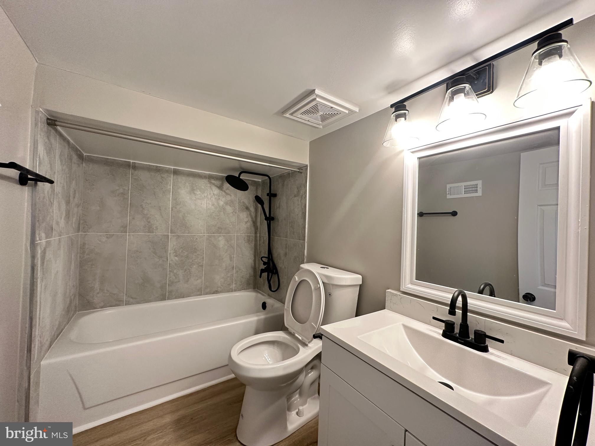 1038 Wedgewood Road Baltimore, MD 21229 - Photo 10 of 12 a bathroom with a sink a toilet and a bathtub