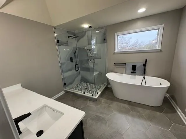 a bathroom with a bathtub and shower