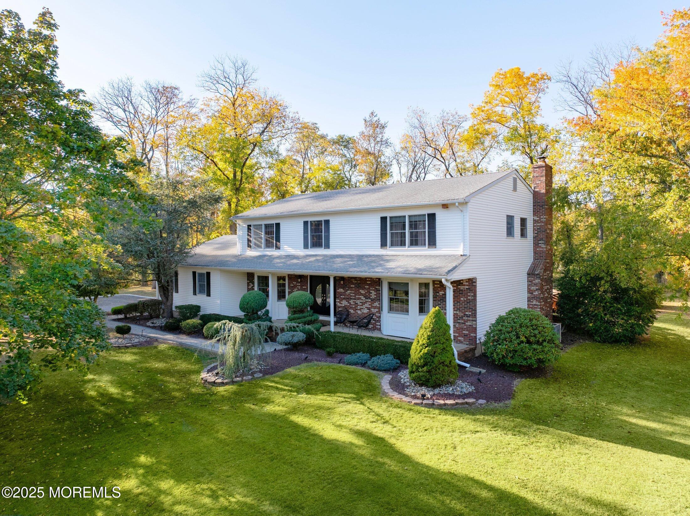 10 Holly Hill Road Marlboro, NJ 07746 - Photo 18 of 19 a view of a house with a yard and potted plants
