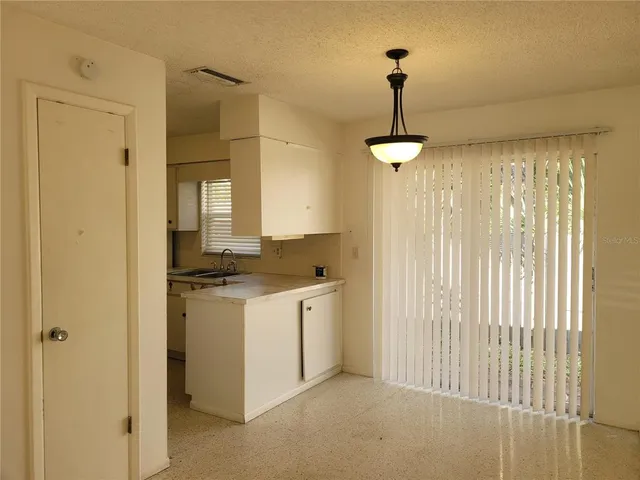 a kitchen with stainless steel appliances granite countertop a sink and a refrigerator