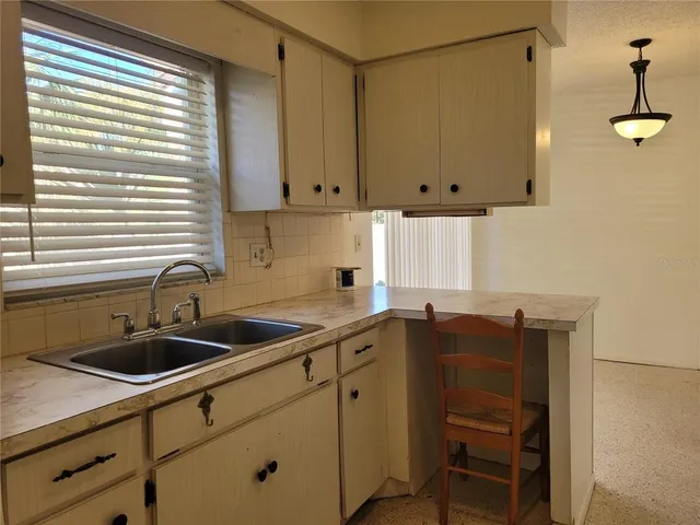 a kitchen with a sink cabinets and window