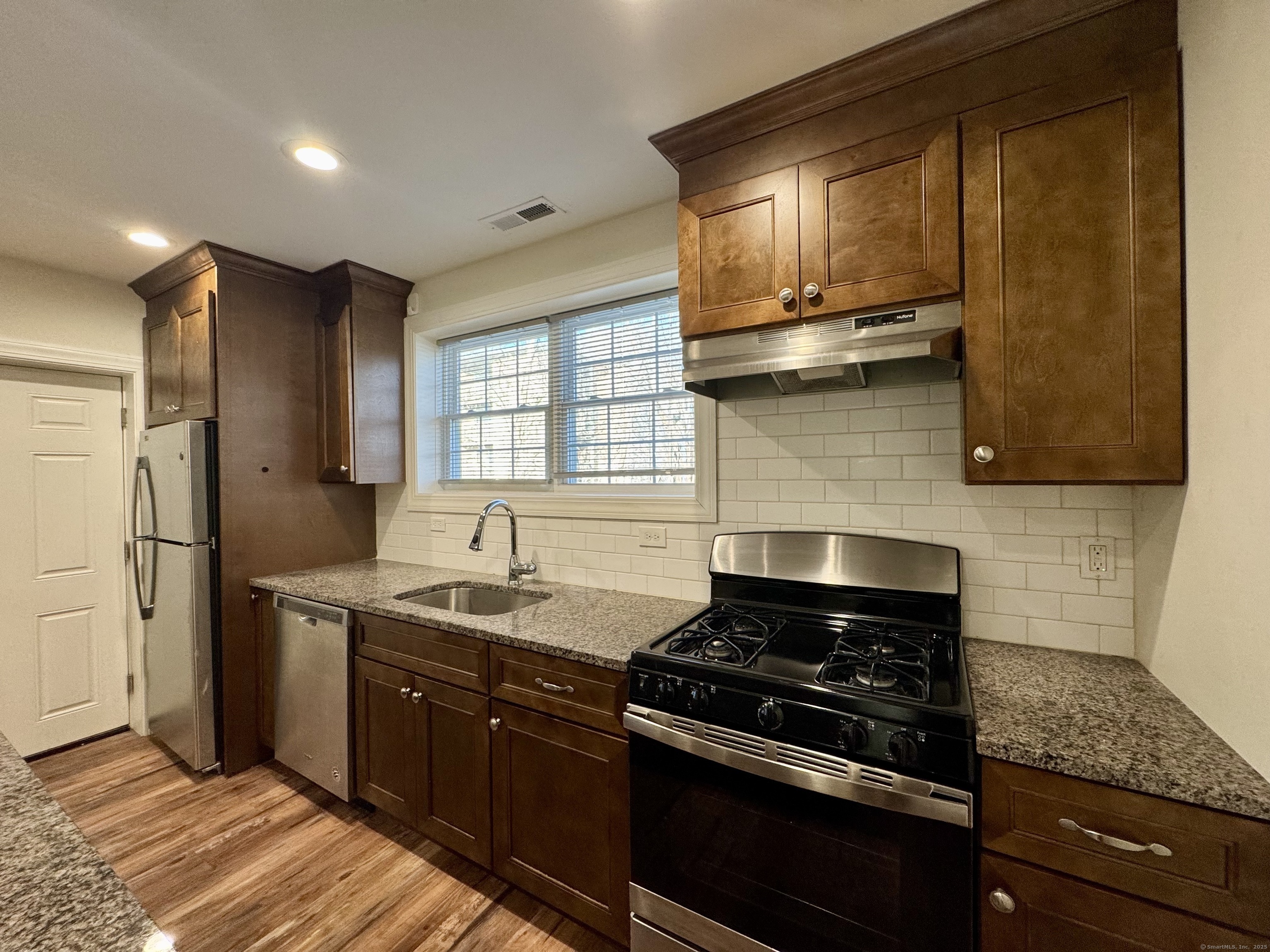 950 Lindley Street Bridgeport, CT 06606 - Photo 6 of 14 a kitchen with a stove and a refrigerator