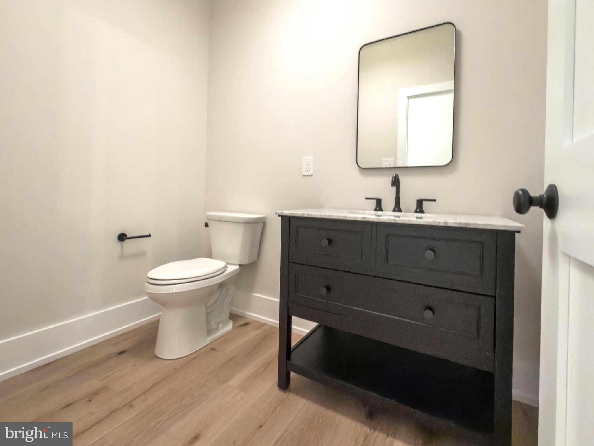 665 Valley View Lane Wayne, PA 19087 - Photo 16 of 34 a bathroom with a toilet sink and mirror