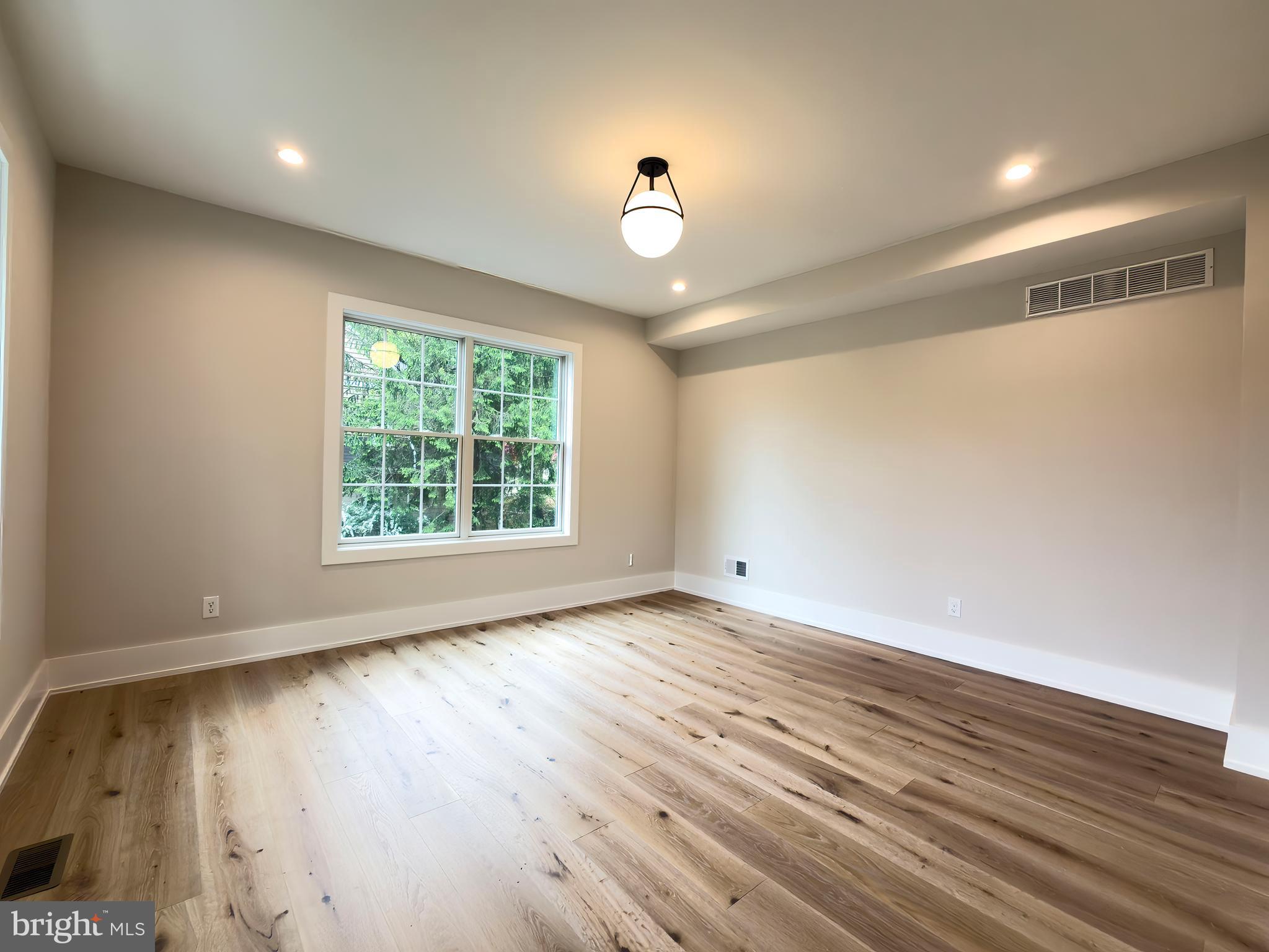 665 Valley View Lane Wayne, PA 19087 - Photo 17 of 34 wooden floor in an empty room with a window