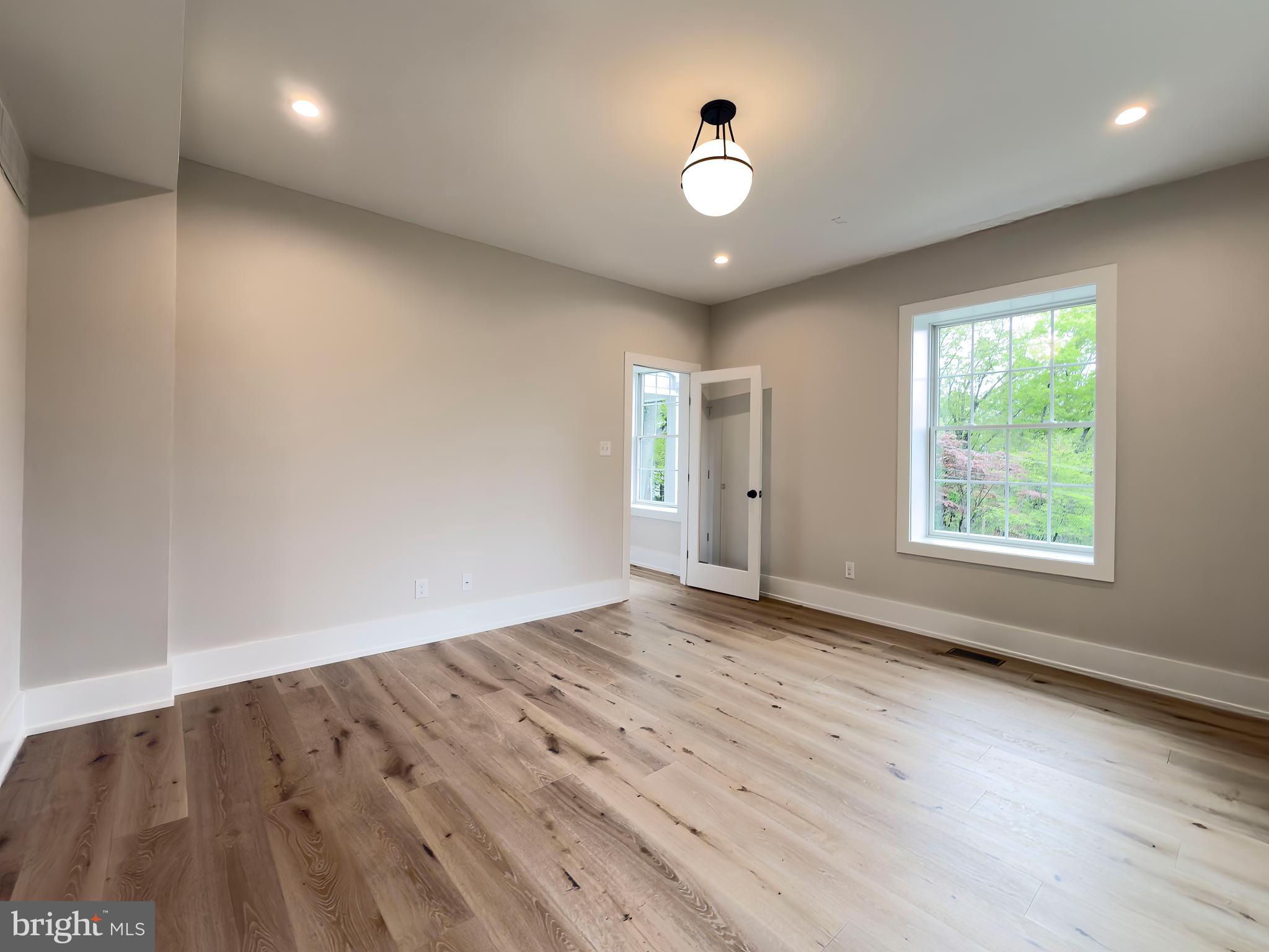 665 Valley View Lane Wayne, PA 19087 - Photo 18 of 34 an empty room with wooden floor and windows