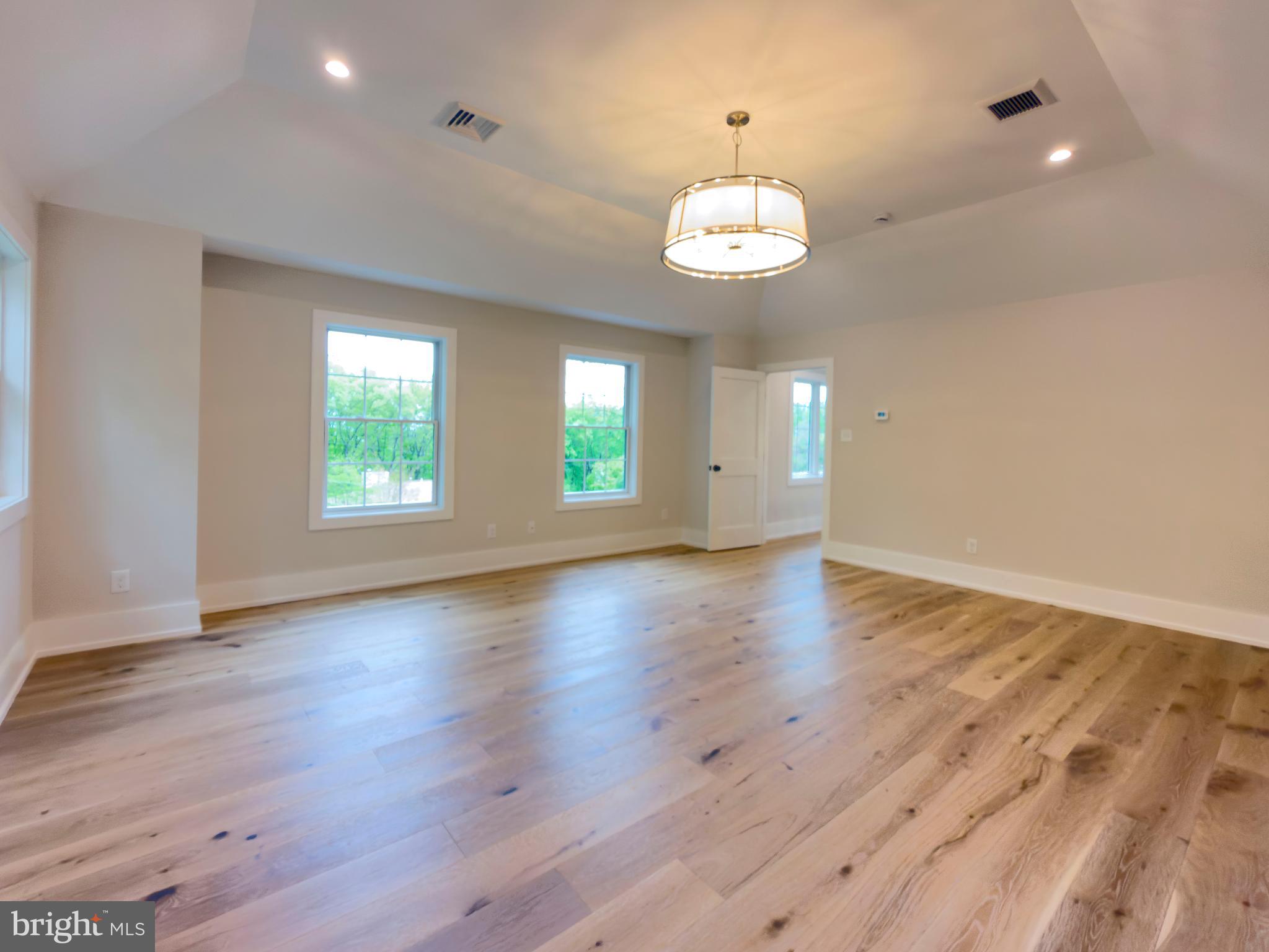 665 Valley View Lane Wayne, PA 19087 - Photo 20 of 34 an empty room with wooden floor and windows