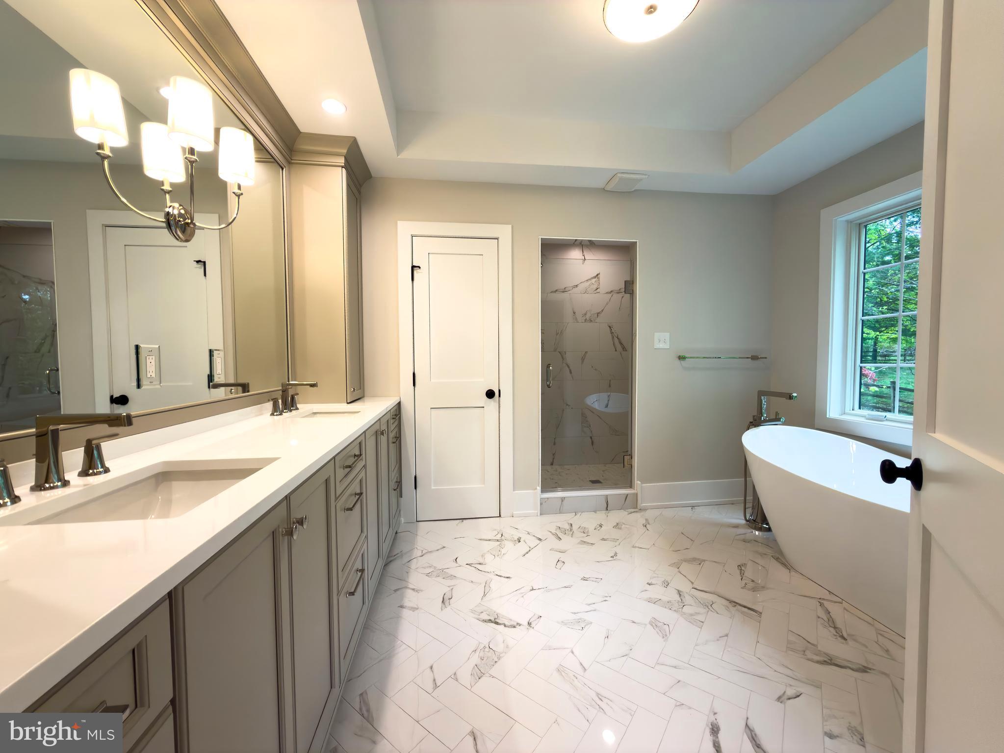 665 Valley View Lane Wayne, PA 19087 - Photo 21 of 34 a spacious bathroom with a bathtub sink and toilet