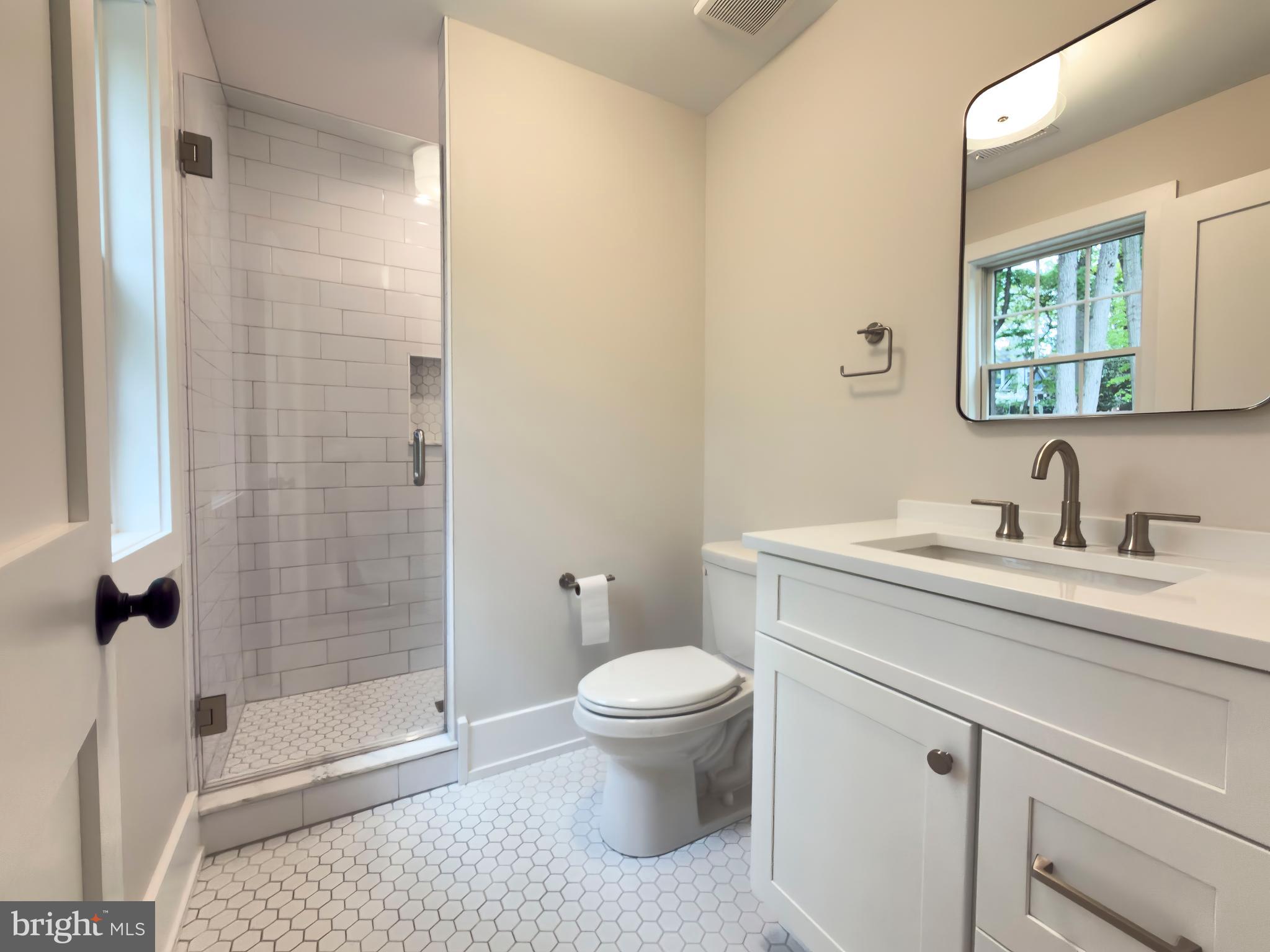 665 Valley View Lane Wayne, PA 19087 - Photo 25 of 34 a bathroom with a granite countertop sink a toilet a mirror and shower