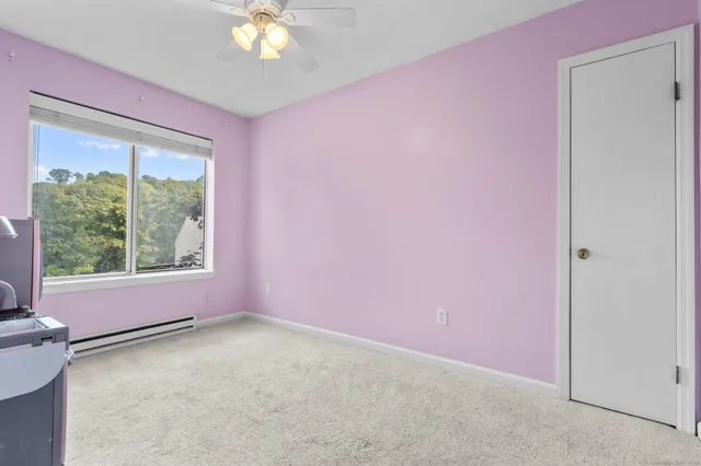 a view of room with window and ceiling fan