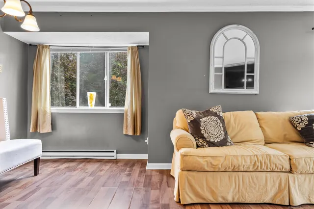 a living room with a couch and a window