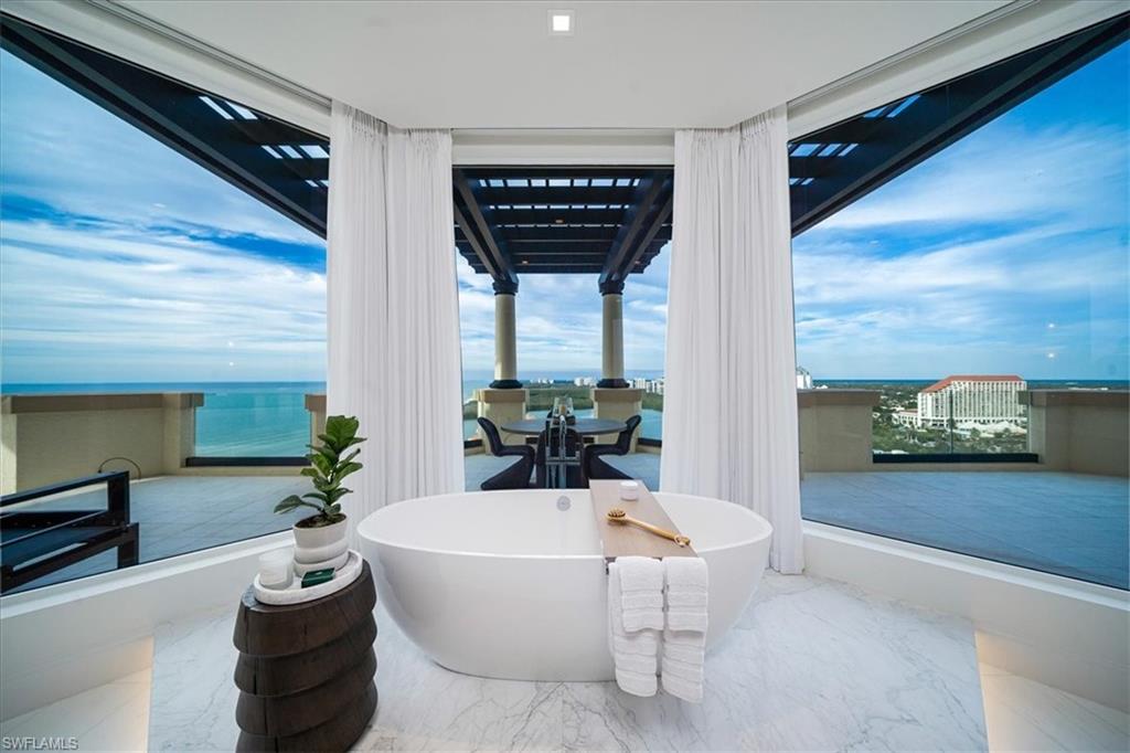 81 Seagate Drive, Unit PH20 Naples, FL 34103 - Photo 18 of 46 a living room with furniture and a large window