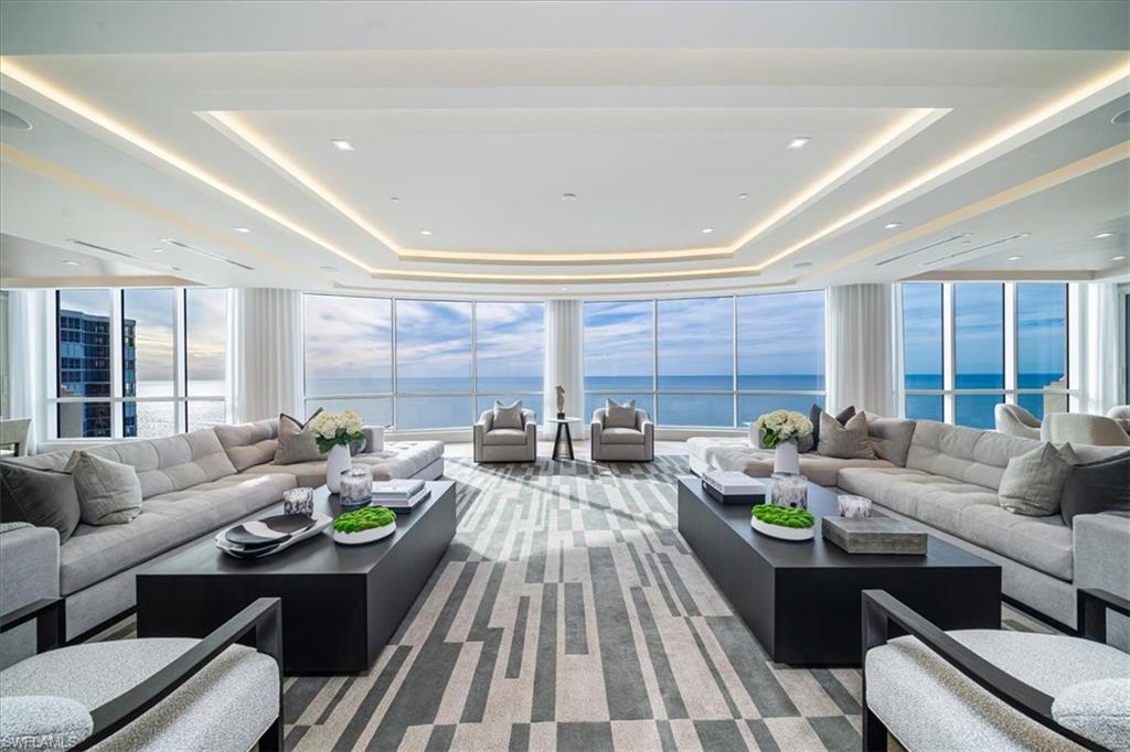 81 Seagate Drive, Unit PH20 Naples, FL 34103 - Photo 29 of 46 a living room with furniture and a large window