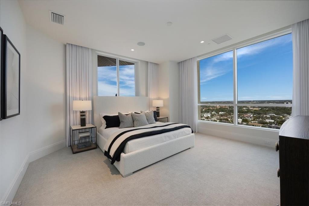 81 Seagate Drive, Unit PH20 Naples, FL 34103 - Photo 35 of 46 a spacious bedroom with a bed and a window