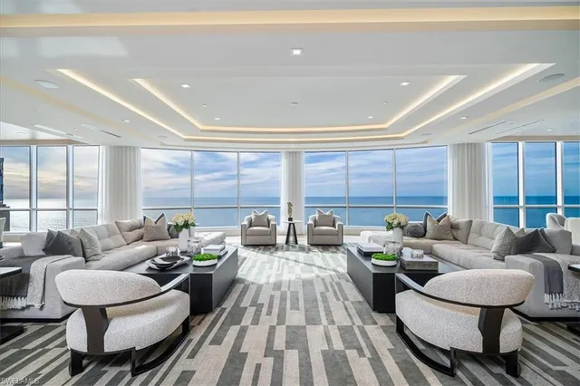 a view of kitchen with stainless steel appliances granite countertop a stove and a large window