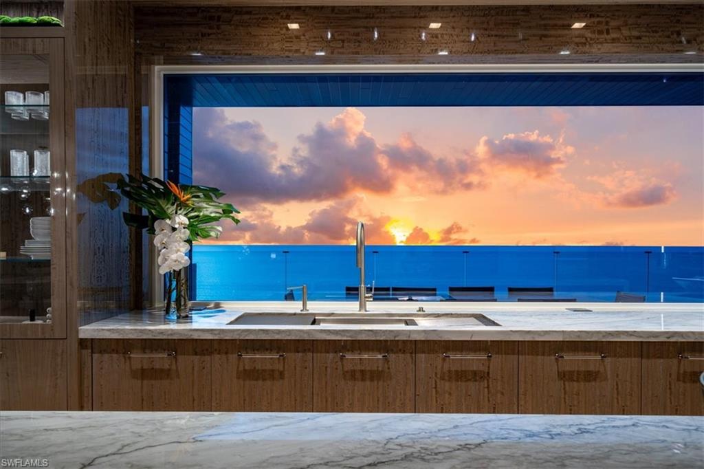 81 Seagate Drive, Unit PH20 Naples, FL 34103 - Photo 5 of 46 a view of kitchen with stainless steel appliances granite countertop a stove and a large window