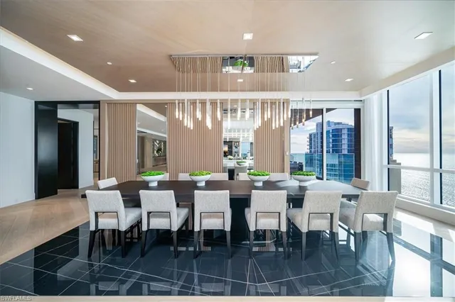 a living room with a large window and furniture