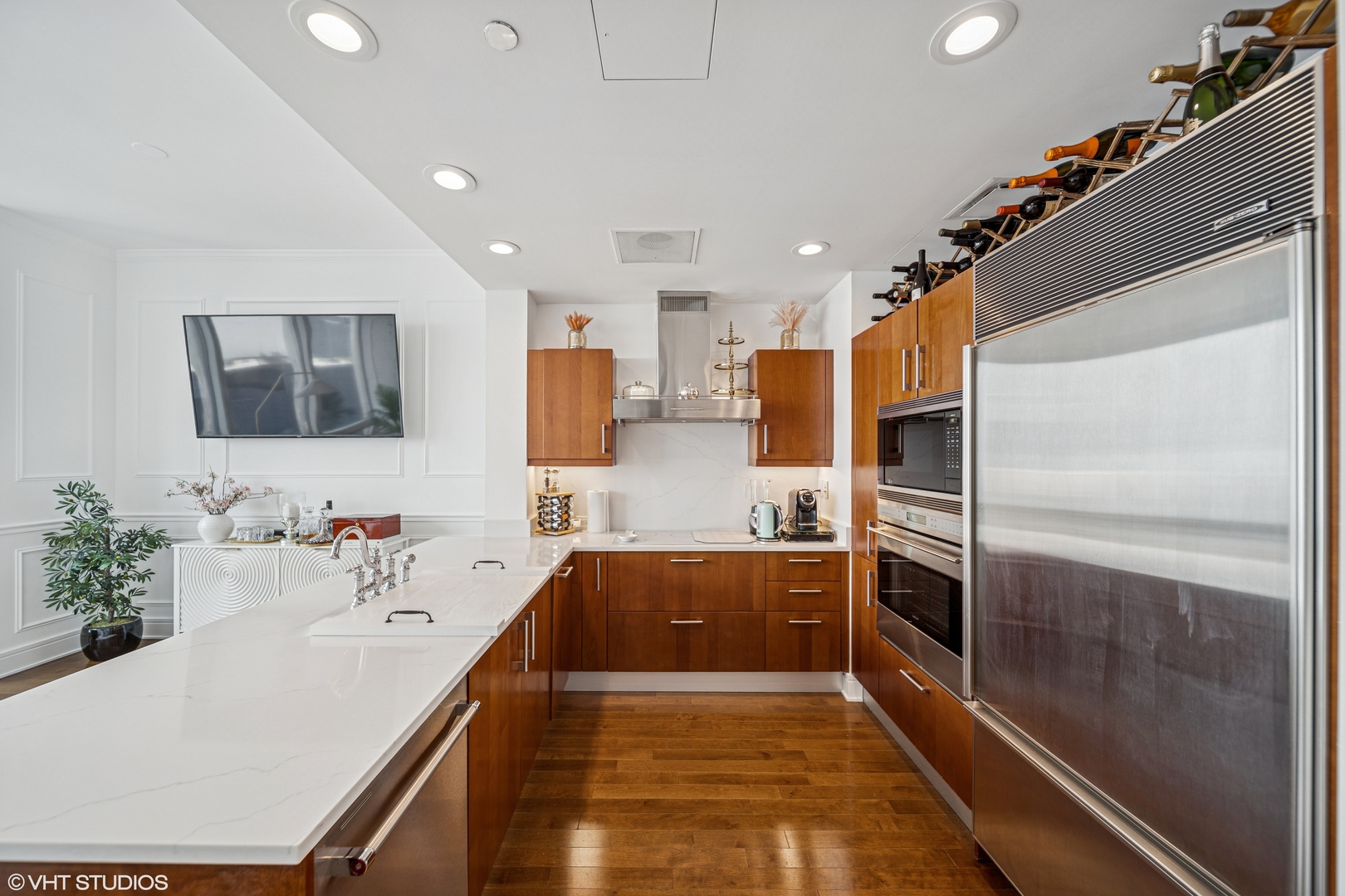 401 North Wabash Avenue, Unit 52C Chicago, IL 60611 - Photo 4 of 20 a large kitchen with kitchen island a sink stainless steel appliances and cabinets