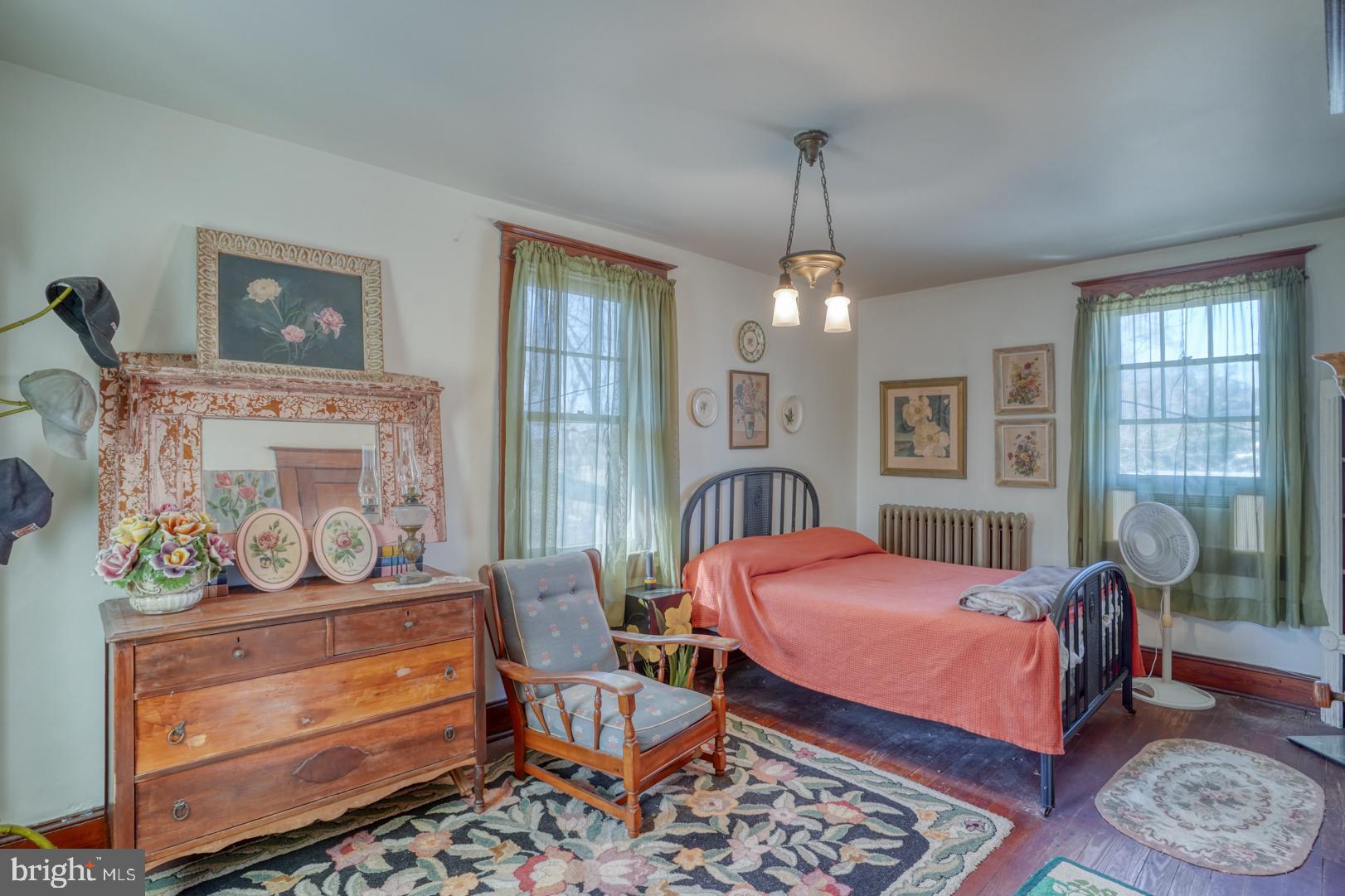 4096 Main Street Trappe, MD 21673 - Photo 53 of 70 a bedroom with a bed a dresser and next to a window