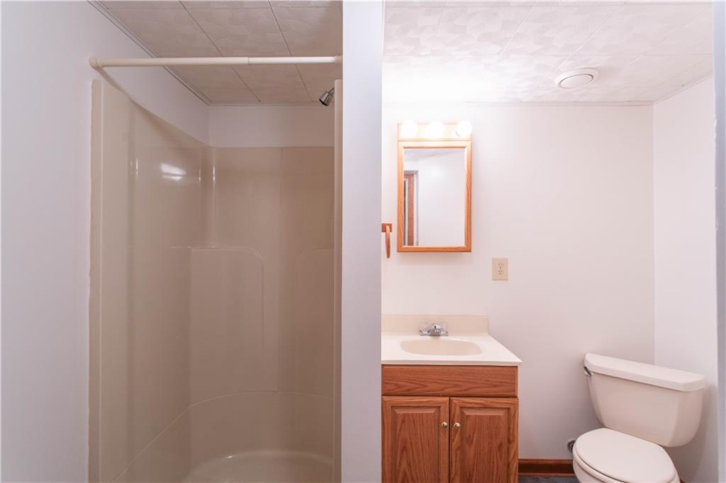 128 Moffett Run Road Aliquippa, PA 15001 - Photo 39 of 48 a bathroom with a toilet a sink and mirror