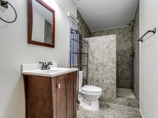 a bathroom with a sink toilet and shower