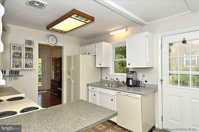 2604 Woodedge Road Silver Spring, MD 20906 - Photo 20 of 30 a kitchen with stainless steel appliances granite countertop a refrigerator sink and cabinets