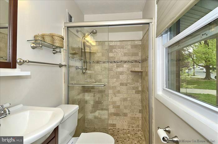 2604 Woodedge Road Silver Spring, MD 20906 - Photo 4 of 30 a bathroom with a shower and a toilet