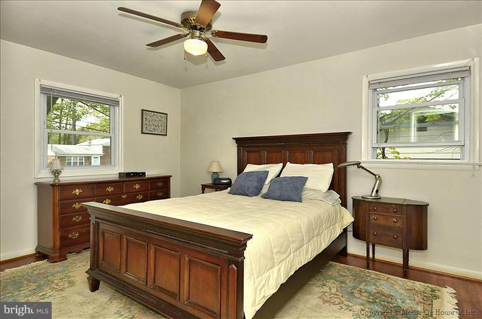 2604 Woodedge Road Silver Spring, MD 20906 - Photo 10 of 30 a bedroom with a bed and a chandelier