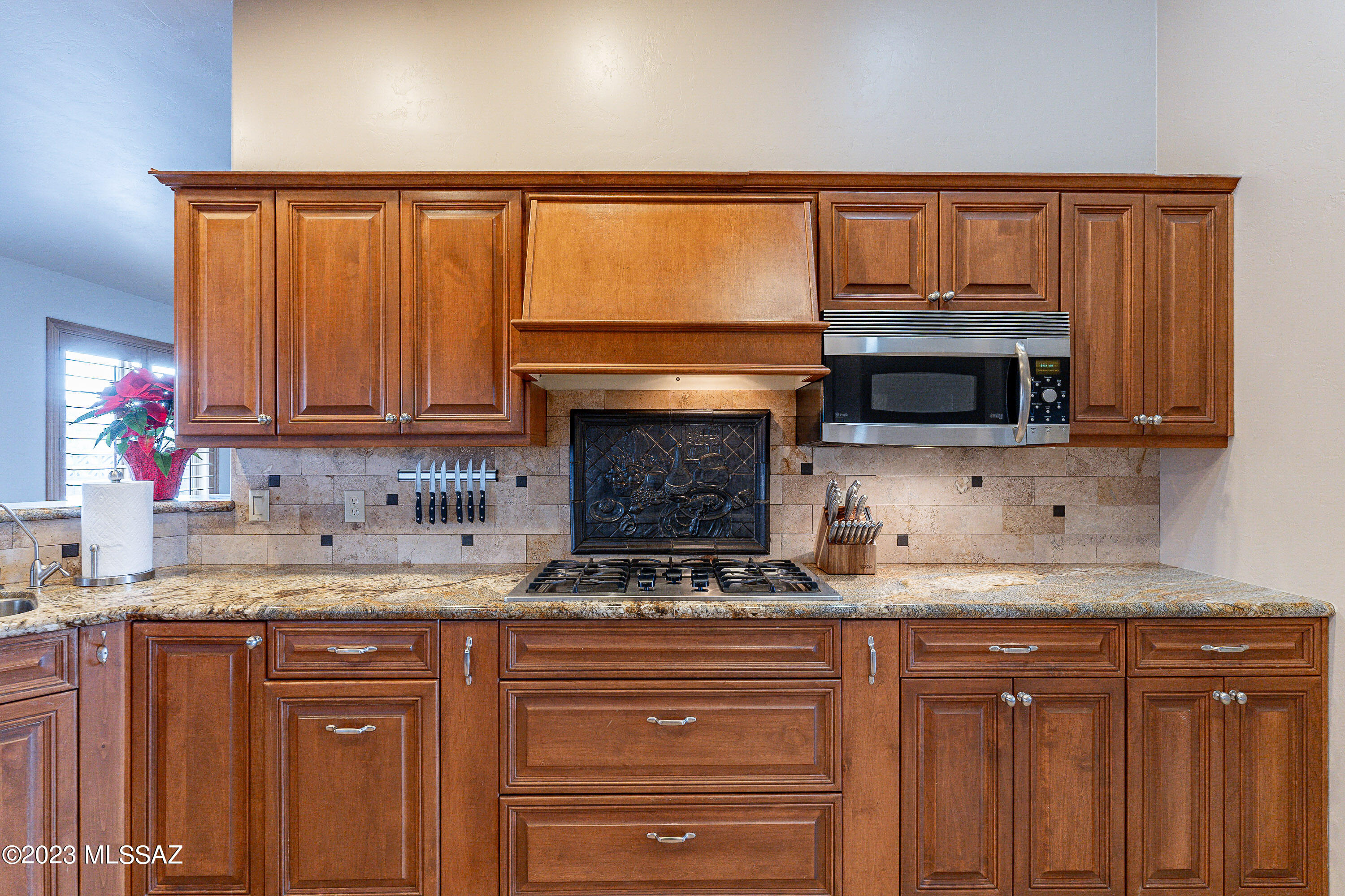 1135 Via San Francisco Rio Rico, AZ 85648 - Photo 11 of 29 a kitchen with granite countertop a sink stove and cabinets