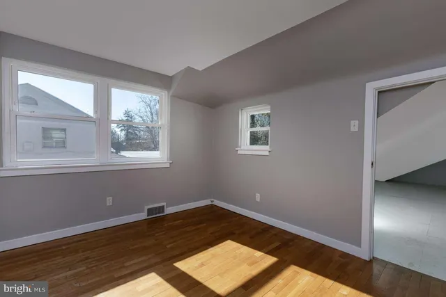 a view of a room with wooden floor and natural light