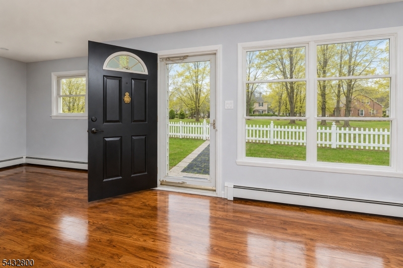 3 Castle Rock Road Lake Hopatcong, NJ 07849 - Photo 2 of 14 a view of empty room with wooden floor and fan
