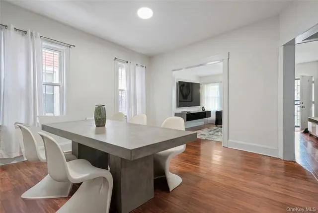 a dining room with furniture and wooden floor