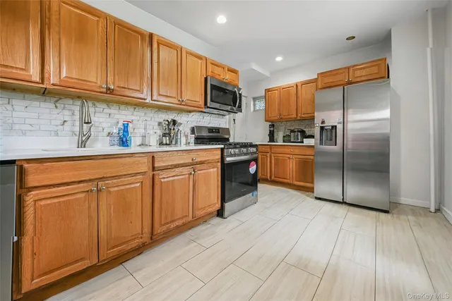 a kitchen with stainless steel appliances granite countertop a refrigerator sink and cabinets