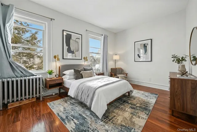 a bedroom with bed and wooden floor