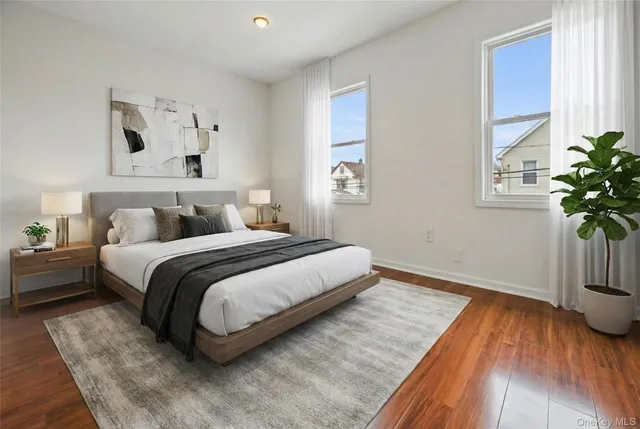 a bedroom with bed and wooden floor