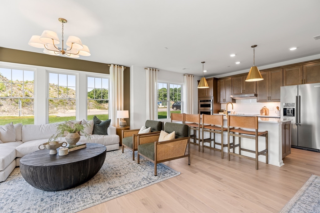 2 Codman Way, Unit 307 Westborough, MA 01581 - Photo 11 of 41 a living room with furniture and a chandelier