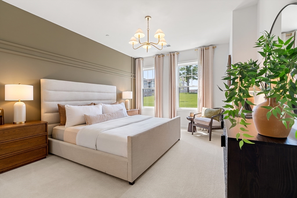 2 Codman Way, Unit 307 Westborough, MA 01581 - Photo 16 of 41 a spacious bedroom with a bed and a chandelier