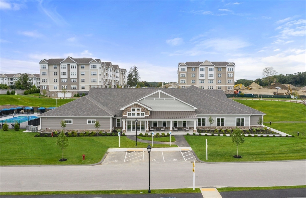 2 Codman Way, Unit 307 Westborough, MA 01581 - Photo 31 of 41 a view of a big house with a big yard and potted plants