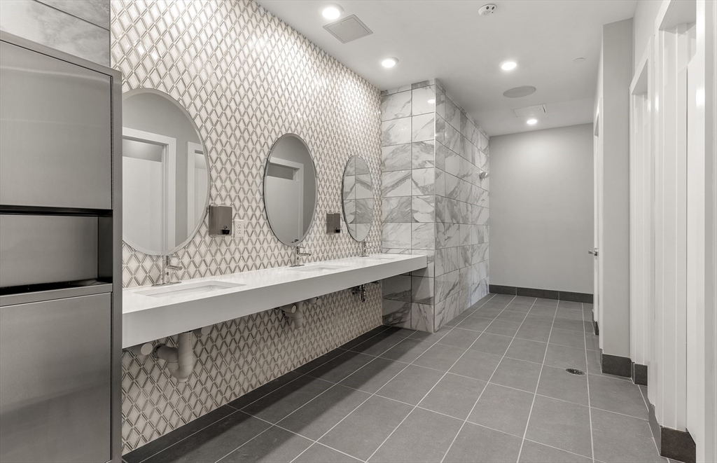 2 Codman Way, Unit 307 Westborough, MA 01581 - Photo 37 of 41 a bathroom with a double vanity sink and a mirror