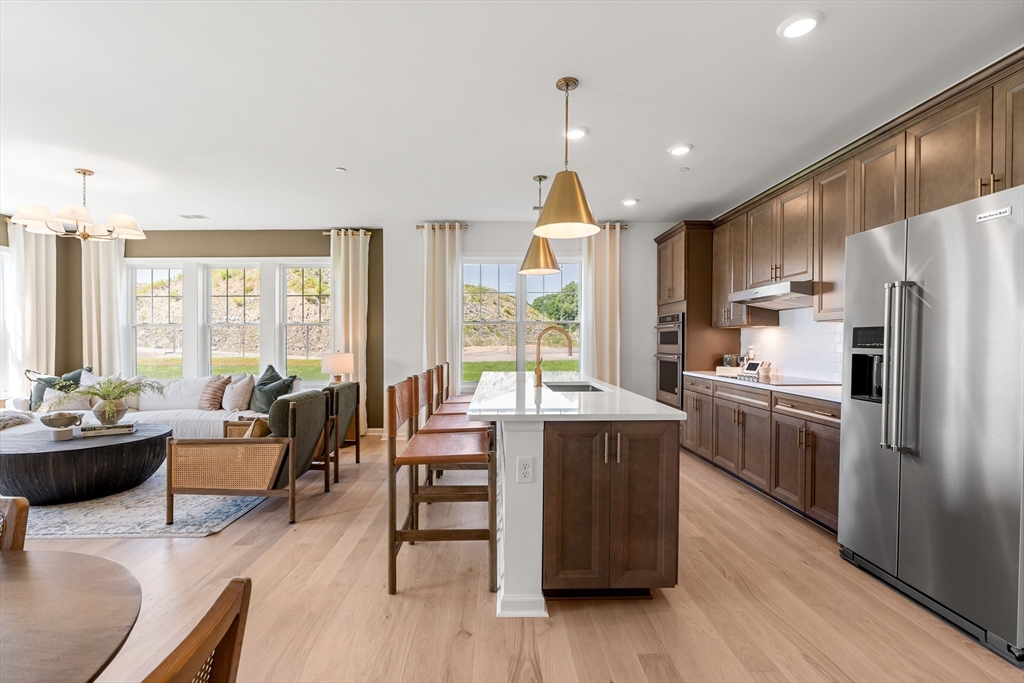2 Codman Way, Unit 307 Westborough, MA 01581 - Photo 7 of 41 a kitchen with sink cabinets and wooden floor