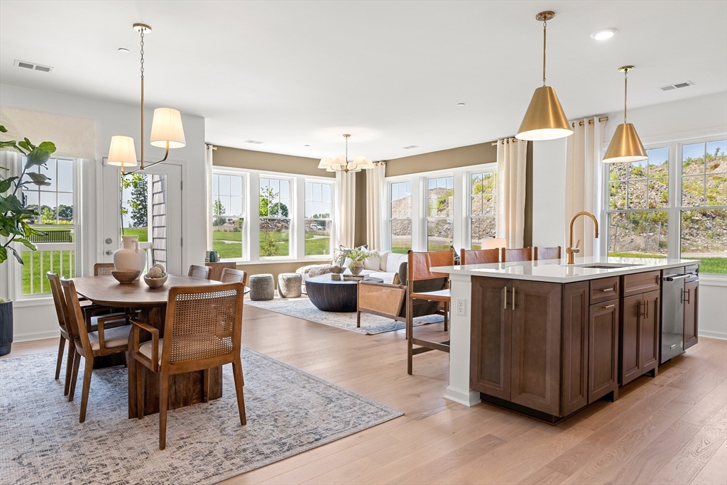 2 Codman Way, Unit 307 Westborough, MA 01581 - Photo 8 of 41 a dining room with furniture a chandelier and wooden floor
