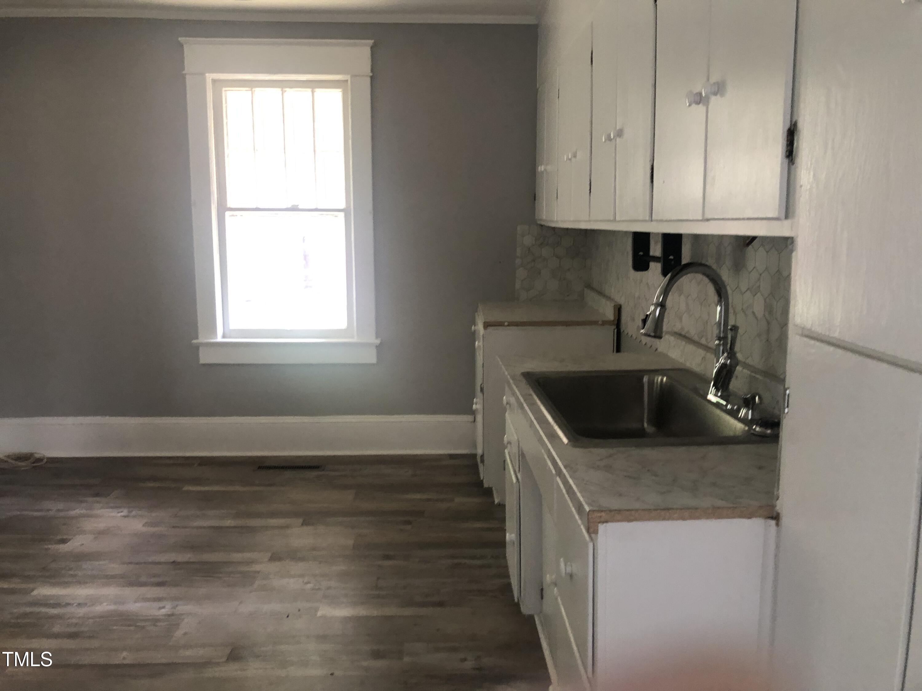 3124 Raleigh Road Henderson, NC 27537 - Photo 11 of 18 a kitchen with granite countertop a sink stove and cabinets