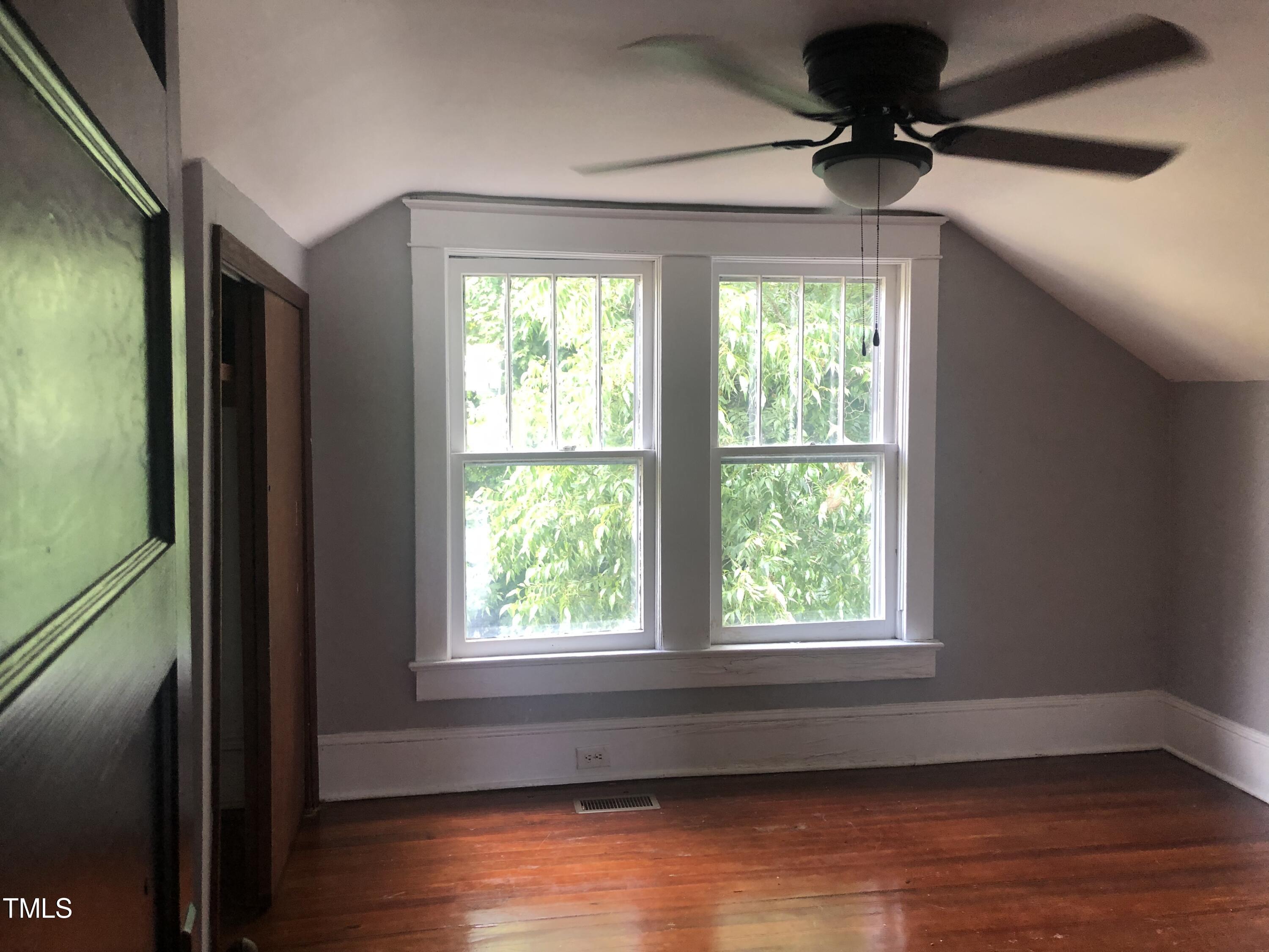 3124 Raleigh Road Henderson, NC 27537 - Photo 16 of 18 a view of an empty room with wooden floor and a window