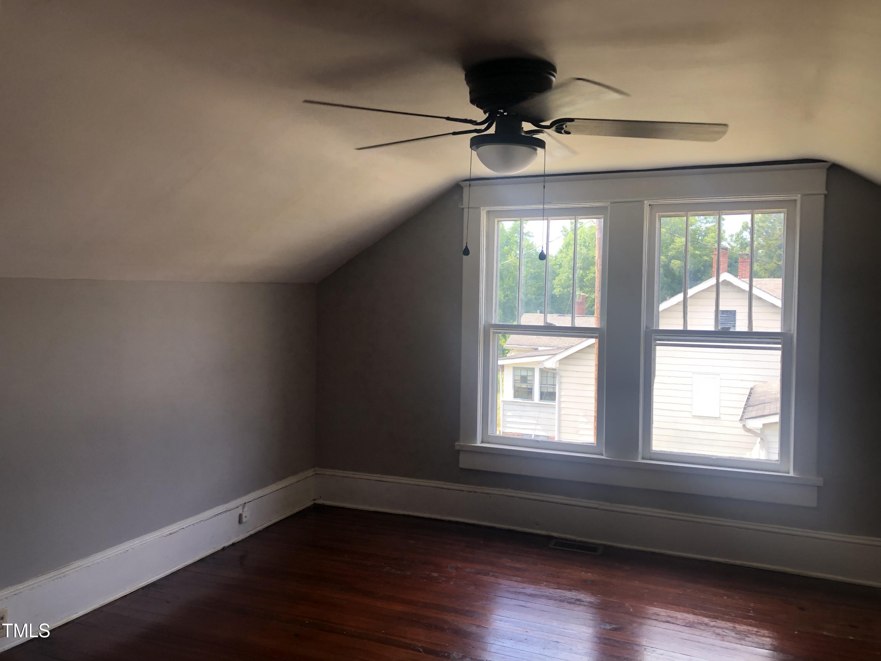 3124 Raleigh Road Henderson, NC 27537 - Photo 17 of 18 a view of an empty room with wooden floor and a window