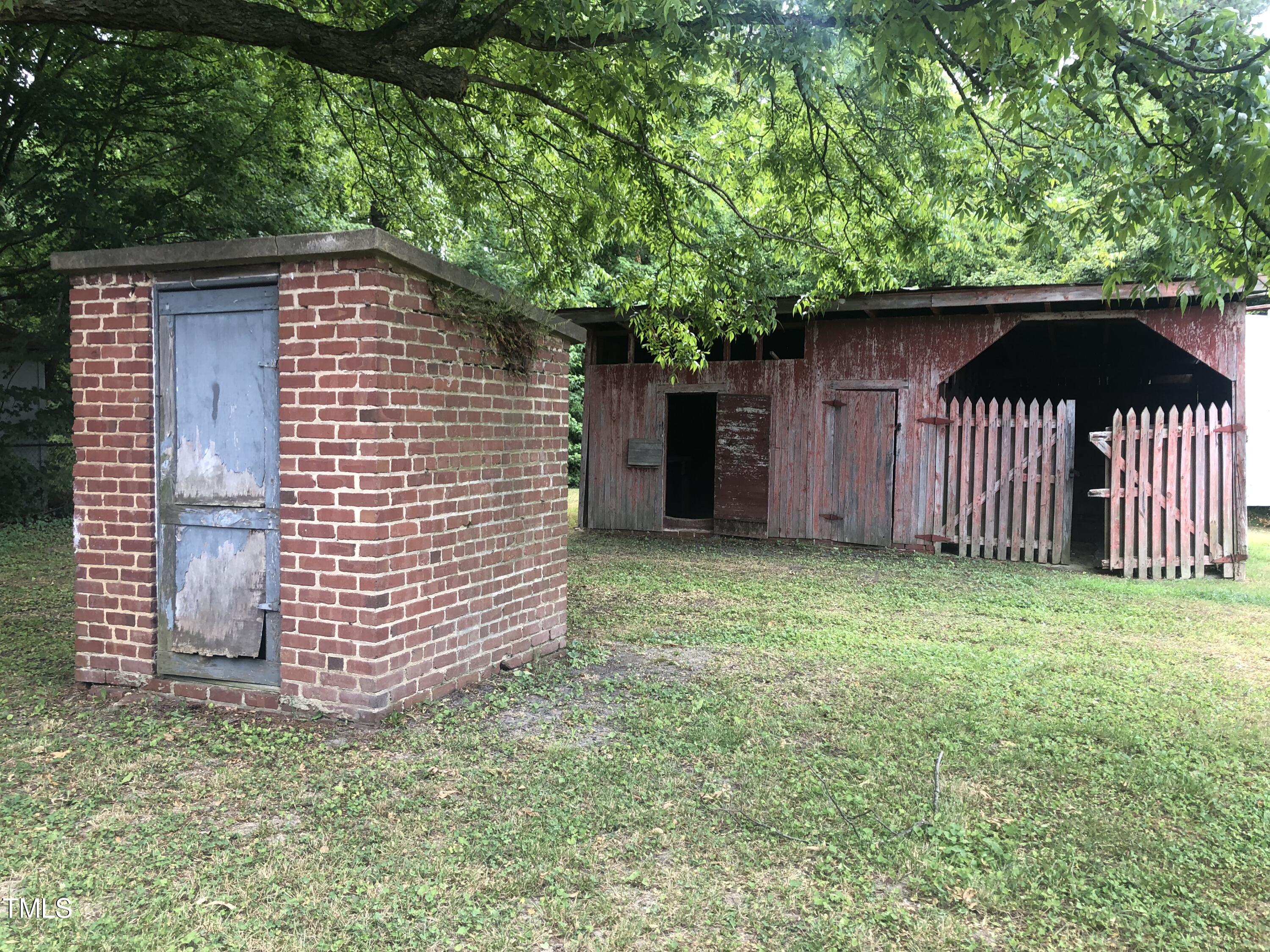 3124 Raleigh Road Henderson, NC 27537 - Photo 3 of 18 a front view of a house with a garden