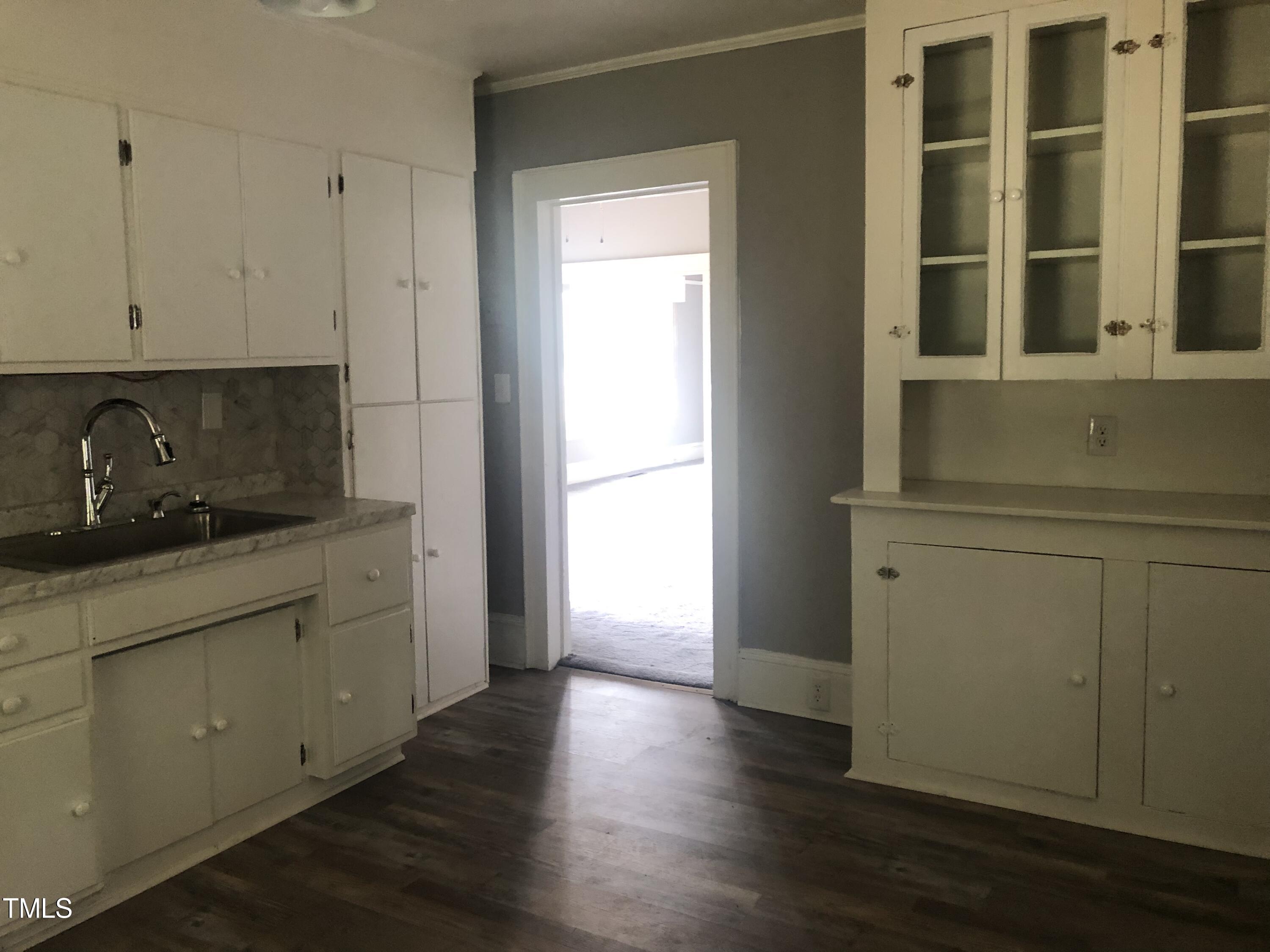 3124 Raleigh Road Henderson, NC 27537 - Photo 10 of 18 a kitchen with a sink and cabinets