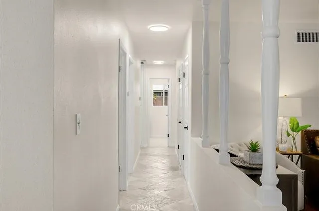 a view of a hallway with wooden shelves
