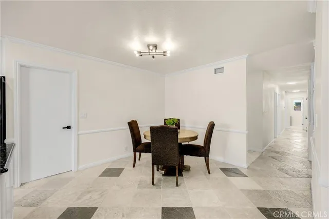 a view of a dining room with furniture and chandelier