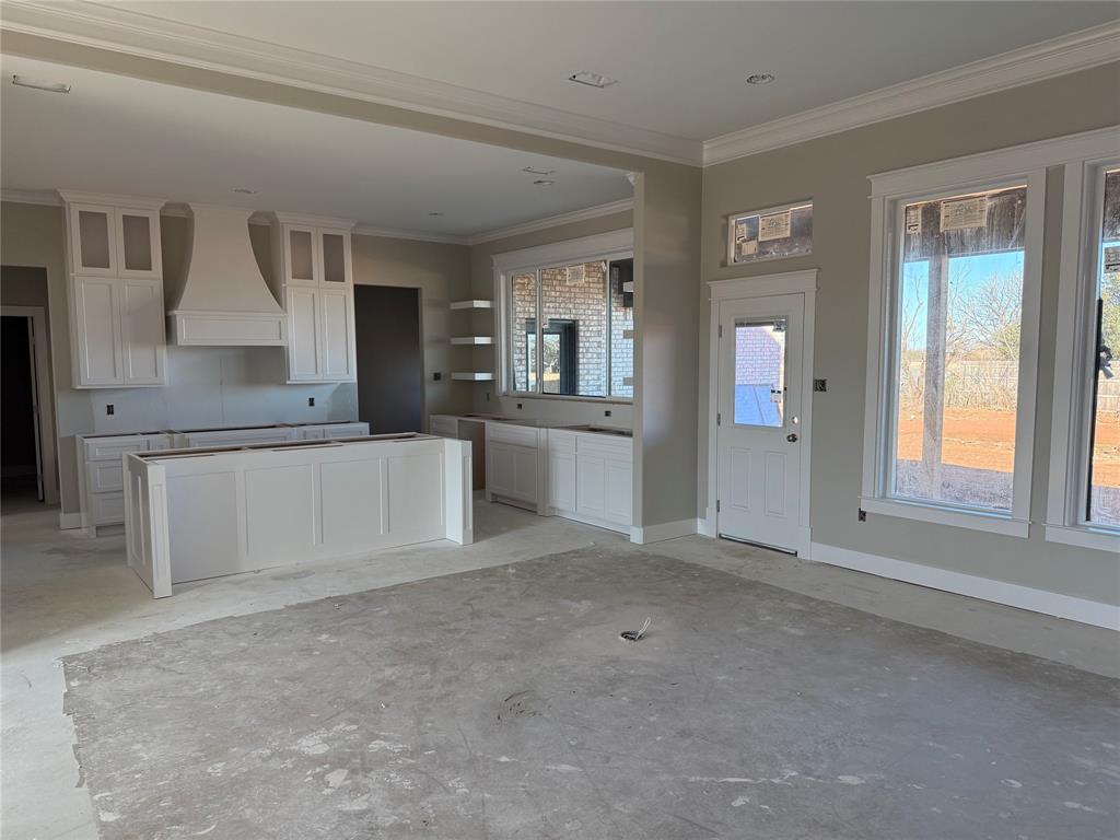 232 Wild Rye Road Abilene, TX 79606 - Photo 3 of 10 an empty room with windows and pillars in it