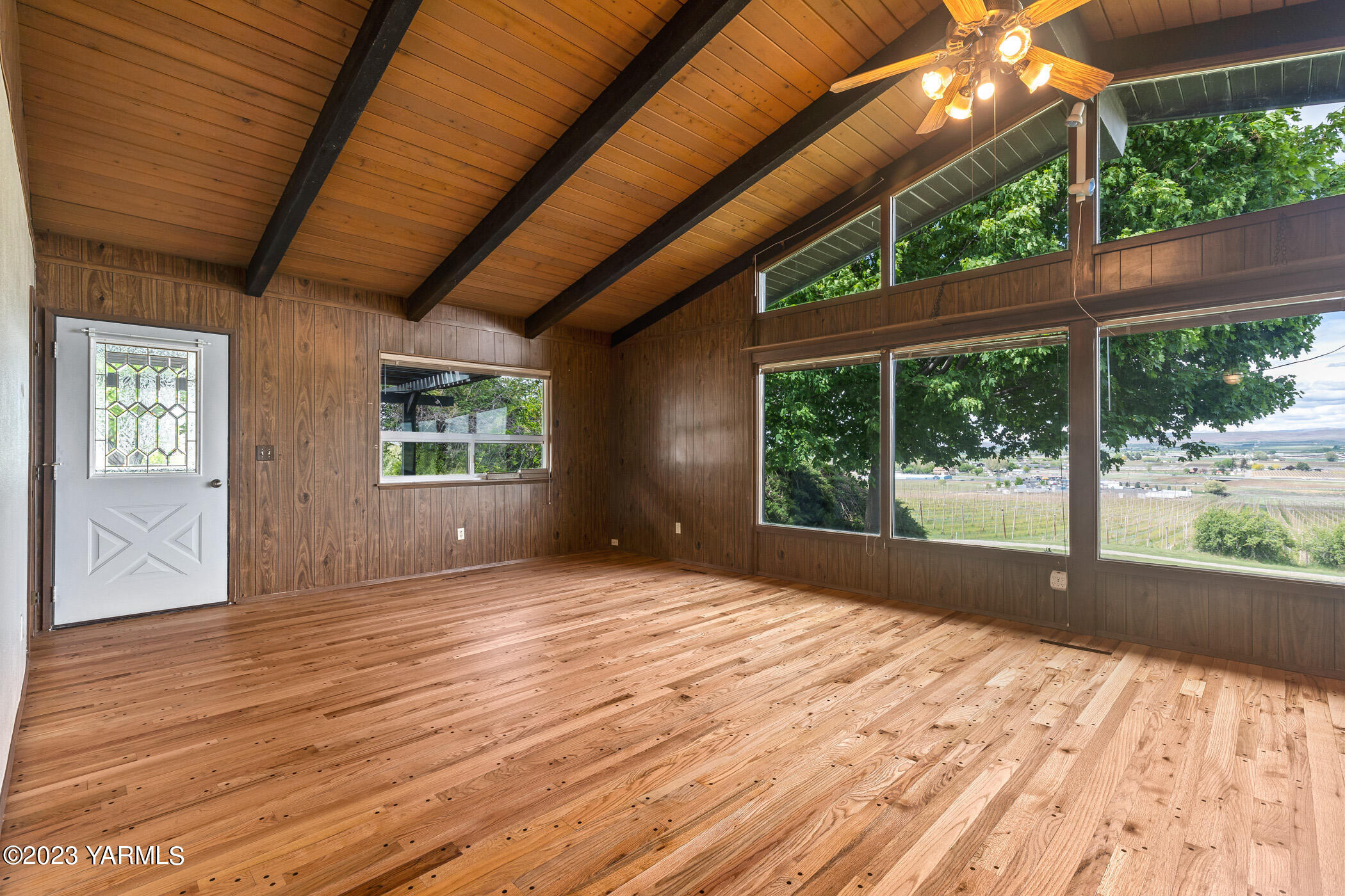 250 Bagley Road Granger, WA 98932 - Photo 3 of 23 a view of an empty room with wooden floor and a window