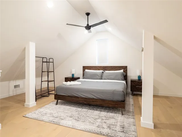 a spacious bedroom with a bed and a table